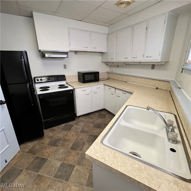 kitchen featuring white cabinetry, black appliances, and a drop ceiling