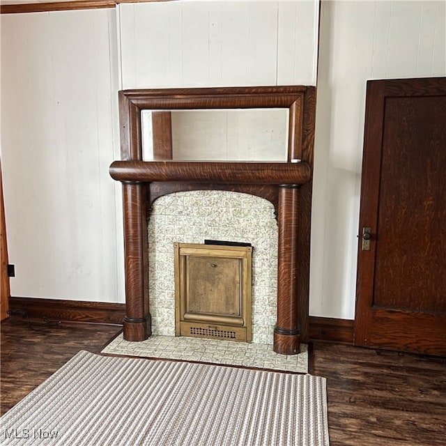 interior details with hardwood / wood-style flooring and wooden walls