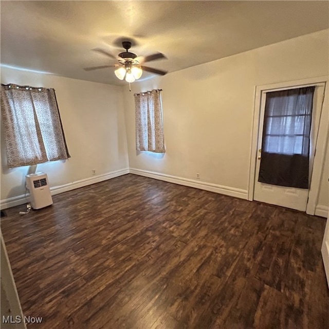 unfurnished room featuring ceiling fan and dark hardwood / wood-style floors