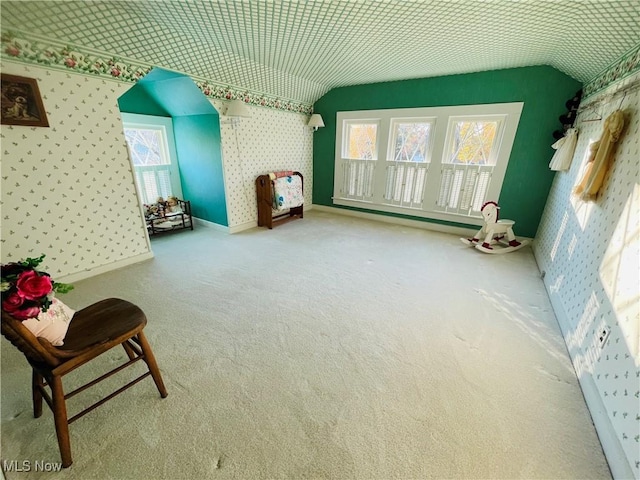 interior space with vaulted ceiling and carpet flooring