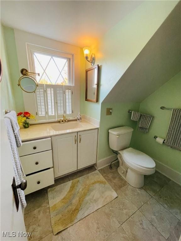 bathroom featuring toilet and vanity