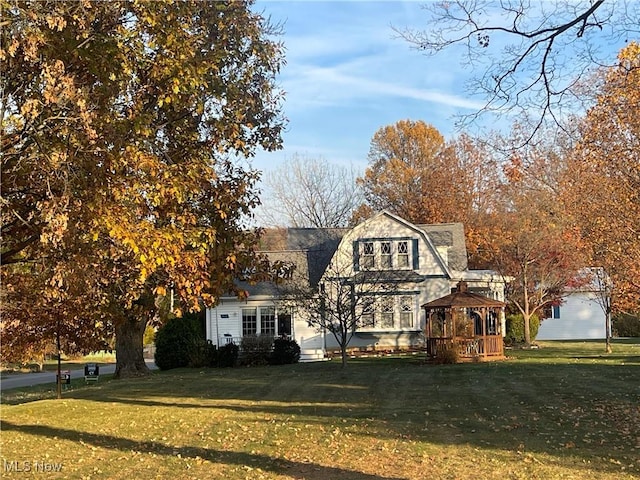 view of front of home featuring a front lawn and a gazebo