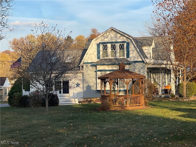 back of house with a gazebo and a yard