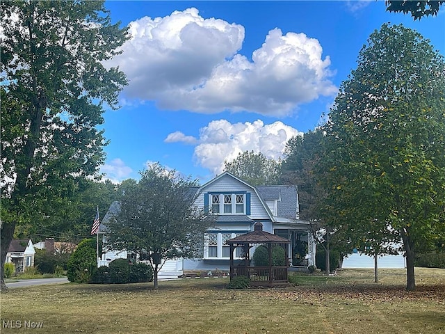 view of front facade with a front yard and a gazebo