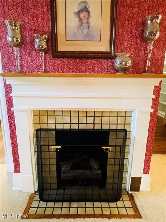 interior details with a tile fireplace