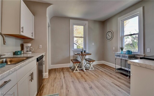 3219 11th St SW, Canton, OH 44710 - kitchen with light wood-style floors, light countertops, and white cabinetry