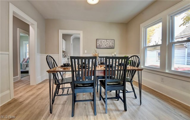 3219 11th St SW, Canton, OH 44710 - dining room with light wood-style floors, a wainscoted wall, plenty of natural light, and baseboards