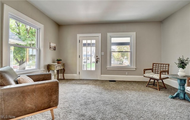 3219 11th St SW, Canton, OH 44710 - doorway with baseboards, visible vents, a healthy amount of sunlight, and carpet