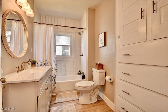 3219 11th St SW, Canton, OH 44710 - full bathroom with vanity, wood finished floors, toilet, baseboards, and shower / tub combo