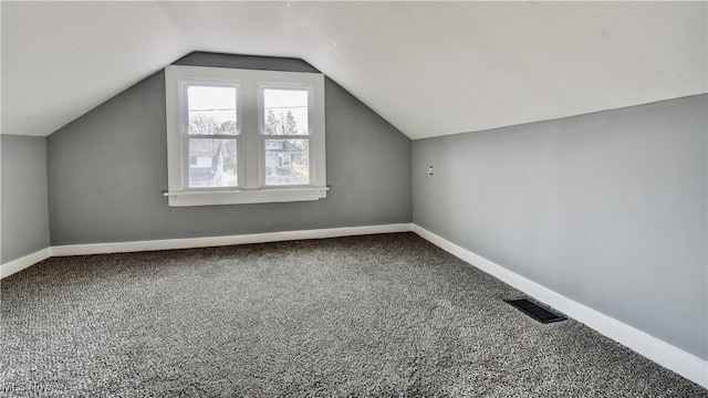 3219 11th St SW, Canton, OH 44710 - additional living space featuring carpet floors, baseboards, visible vents, and lofted ceiling