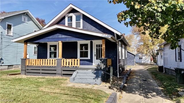 bungalow-style home featuring a porch and a front yard