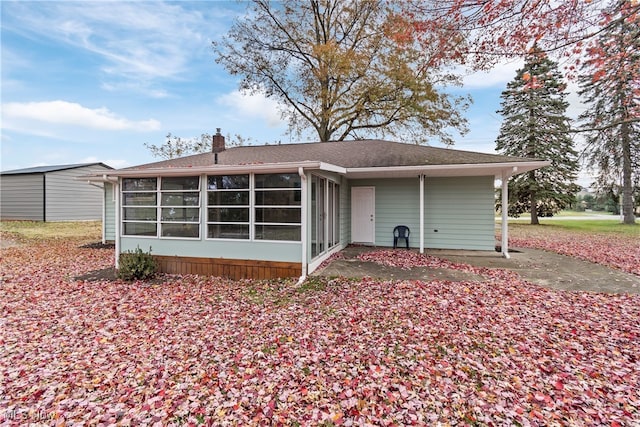 back of house featuring a sunroom