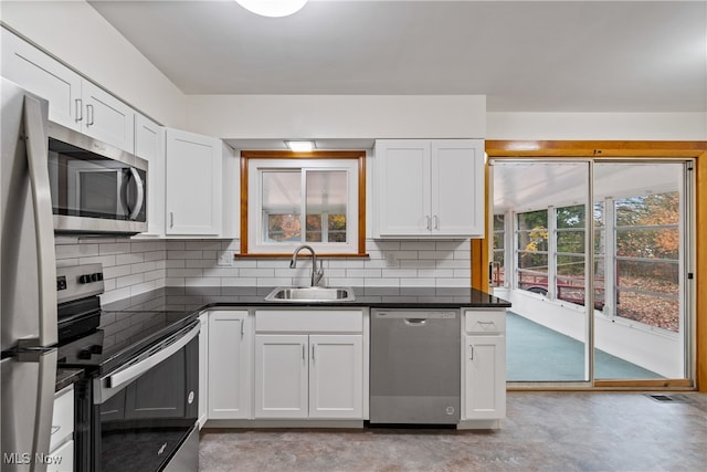 kitchen with appliances with stainless steel finishes, white cabinets, and sink