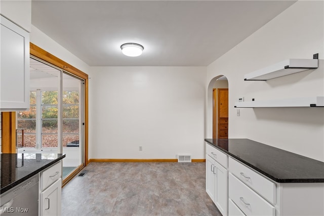 kitchen with white dishwasher and white cabinetry