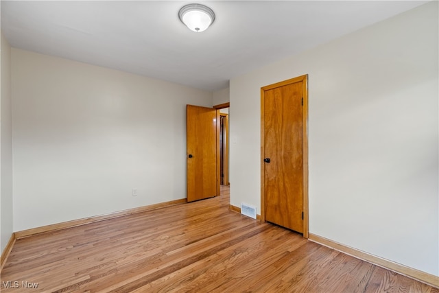 empty room with light hardwood / wood-style floors