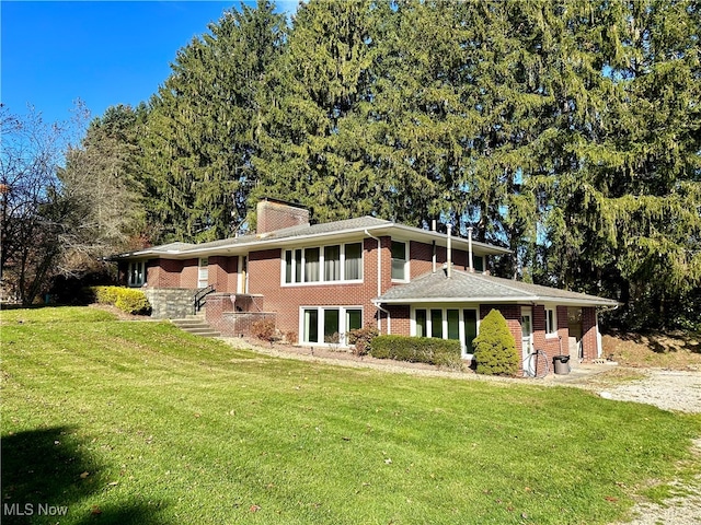 rear view of house with a lawn