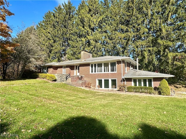 rear view of property featuring a yard