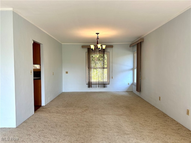 unfurnished room with carpet, an inviting chandelier, and ornamental molding