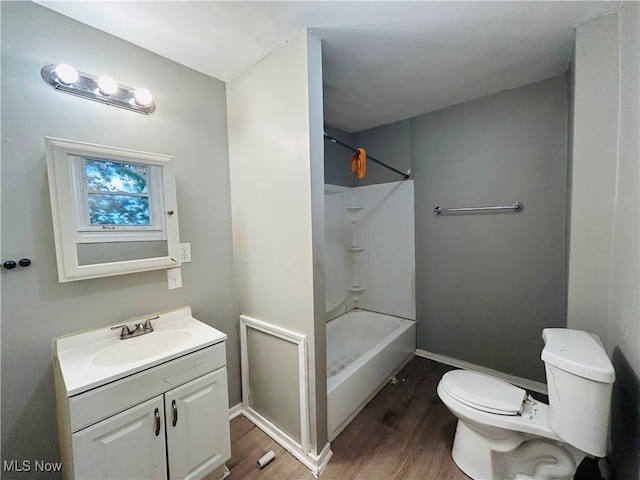 full bathroom with toilet, bathtub / shower combination, vanity, and wood-type flooring