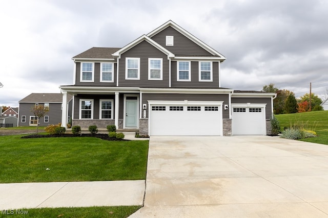 view of front of home with a front yard and a garage