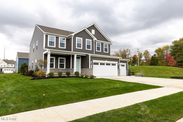 craftsman-style home featuring a front yard, a garage, and a porch