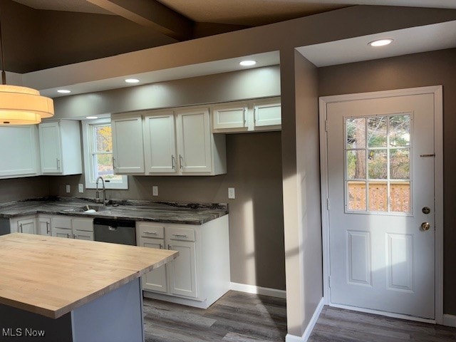 kitchen featuring white cabinetry, vaulted ceiling with beams, and dark hardwood / wood-style floors