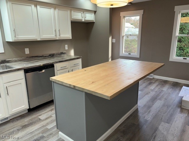 kitchen with dishwasher, white cabinets, hardwood / wood-style floors, and plenty of natural light