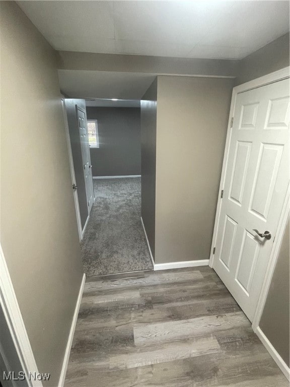 hall with dark wood-type flooring