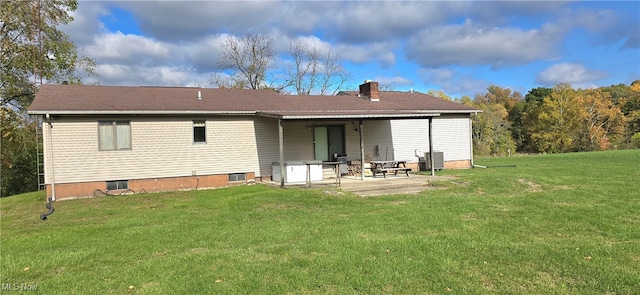 back of house with central AC, a yard, and a patio area