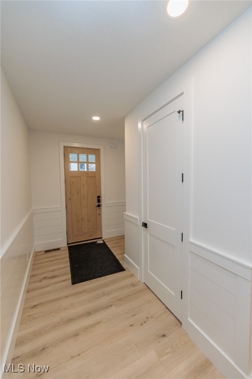 foyer entrance with light hardwood / wood-style floors