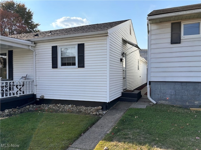 view of side of home with a lawn