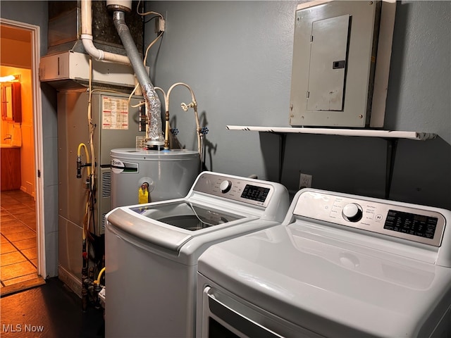 clothes washing area with electric panel, washing machine and clothes dryer, and dark tile patterned flooring