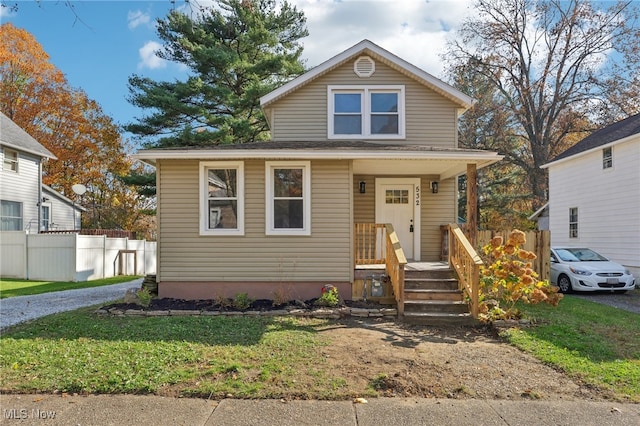 bungalow-style house with a front lawn and a porch