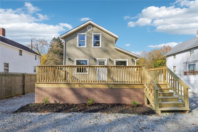 back of house with a deck