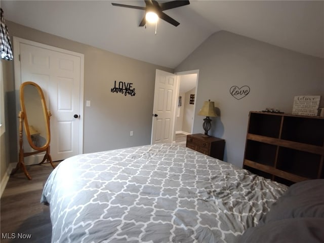 bedroom featuring ceiling fan, dark hardwood / wood-style flooring, and lofted ceiling