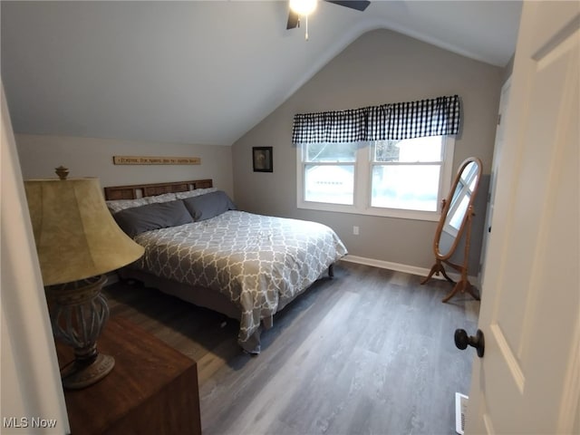 bedroom with wood-type flooring, vaulted ceiling, and ceiling fan