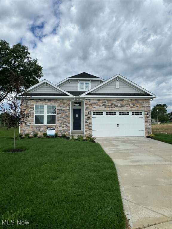 view of front of house with a front yard and a garage