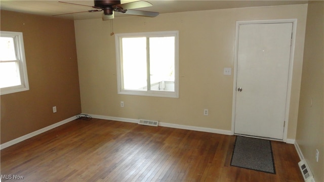 empty room featuring ceiling fan and dark hardwood / wood-style floors