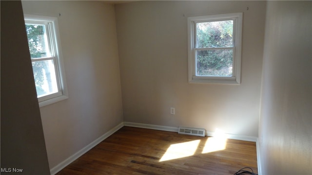 spare room featuring dark wood-type flooring