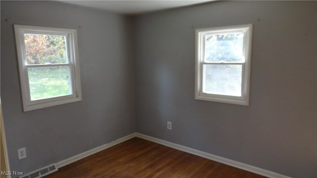 empty room featuring dark hardwood / wood-style floors