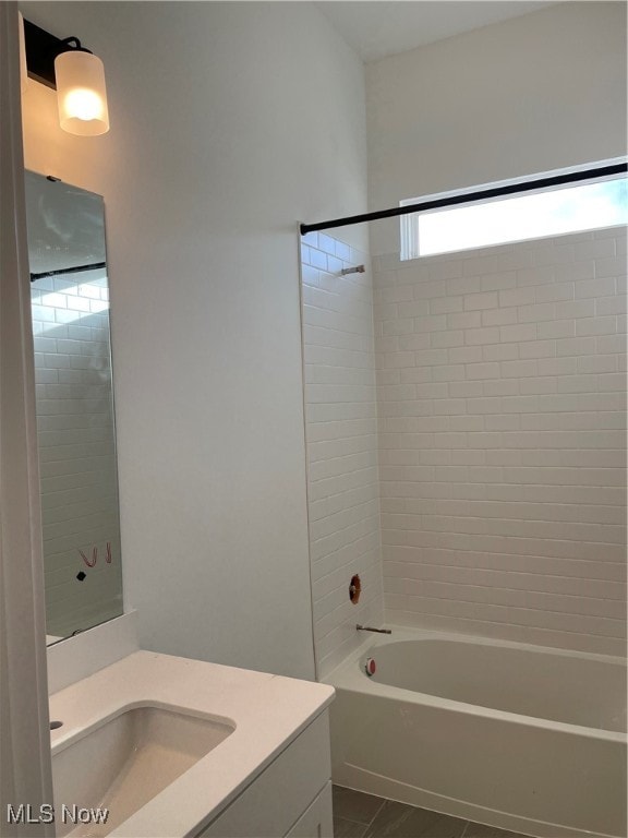 bathroom with vanity, tiled shower / bath combo, and tile patterned floors