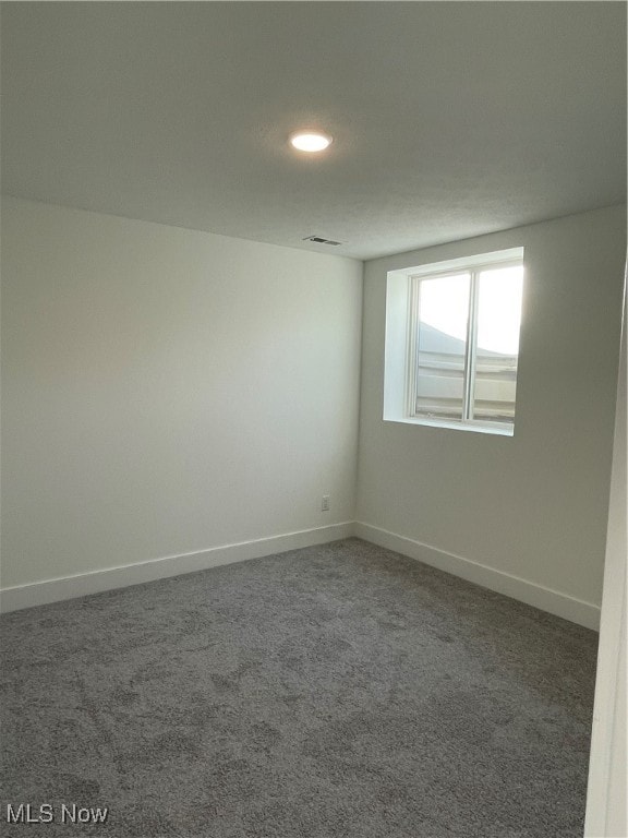 unfurnished room featuring carpet flooring