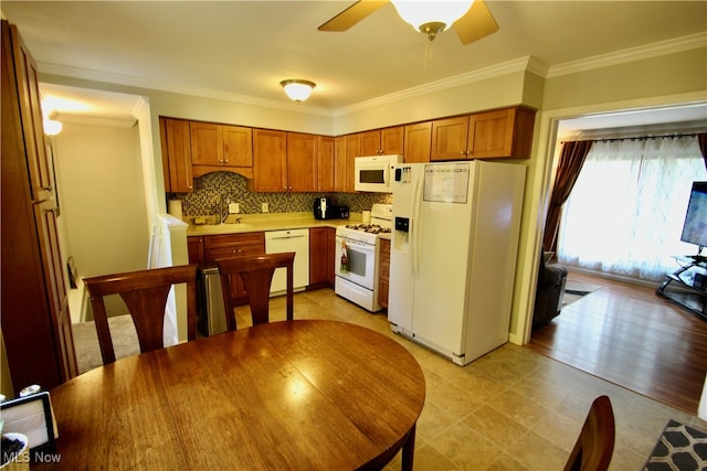 kitchen featuring ceiling fan, crown molding, white appliances, and sink