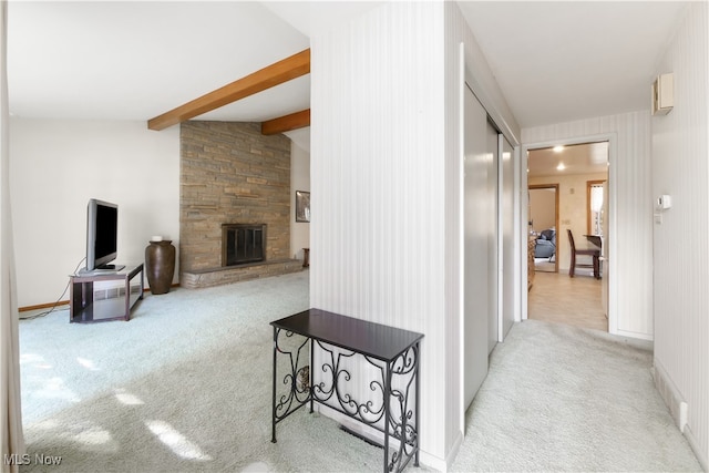 hallway with lofted ceiling with beams and light carpet