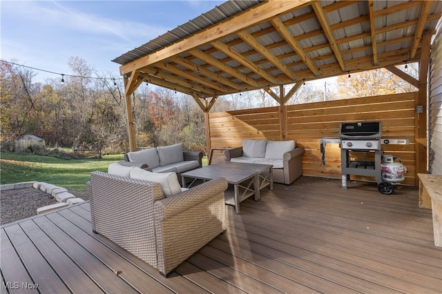 wooden terrace with an outdoor hangout area, a yard, and area for grilling