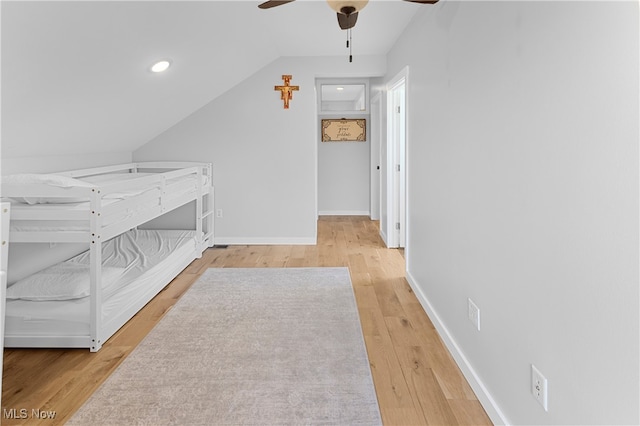 unfurnished bedroom with wood-type flooring, vaulted ceiling, and ceiling fan