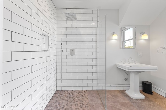 bathroom with tile patterned floors and a tile shower