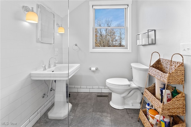 bathroom featuring toilet and tile patterned floors