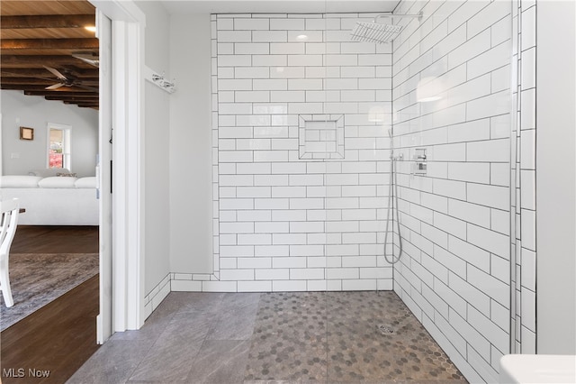 bathroom featuring a tile shower, wood ceiling, lofted ceiling with beams, and hardwood / wood-style floors