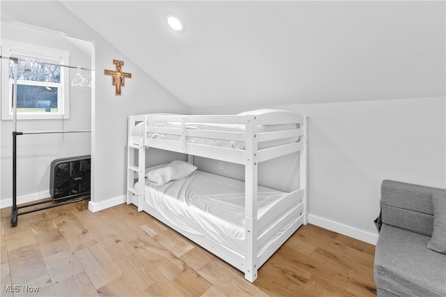 bedroom with lofted ceiling and hardwood / wood-style flooring